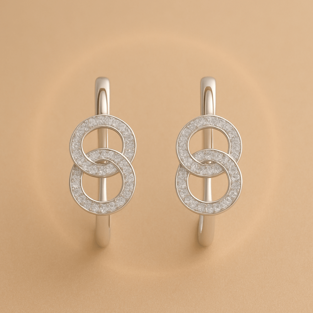 Silver earrings with interlocking circular design and diamonds.