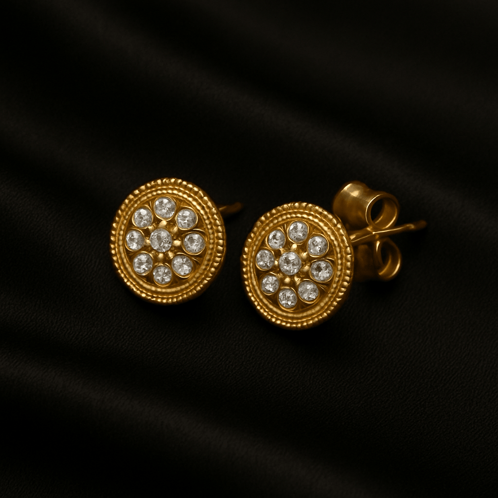 Pair of gold stud earrings with clustered diamond pattern on black satin.