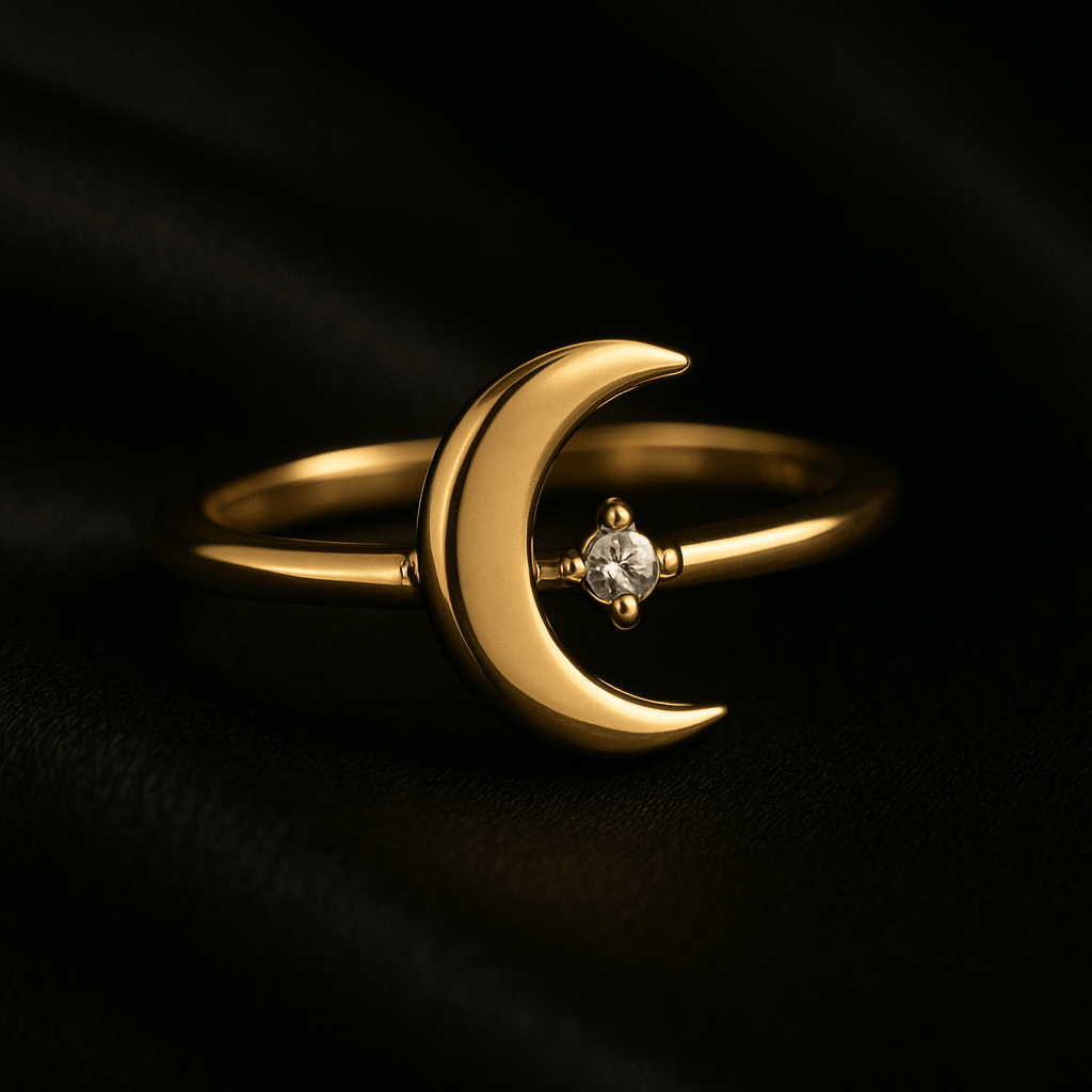 Gold ring featuring a smooth crescent moon design with a centered white gemstone